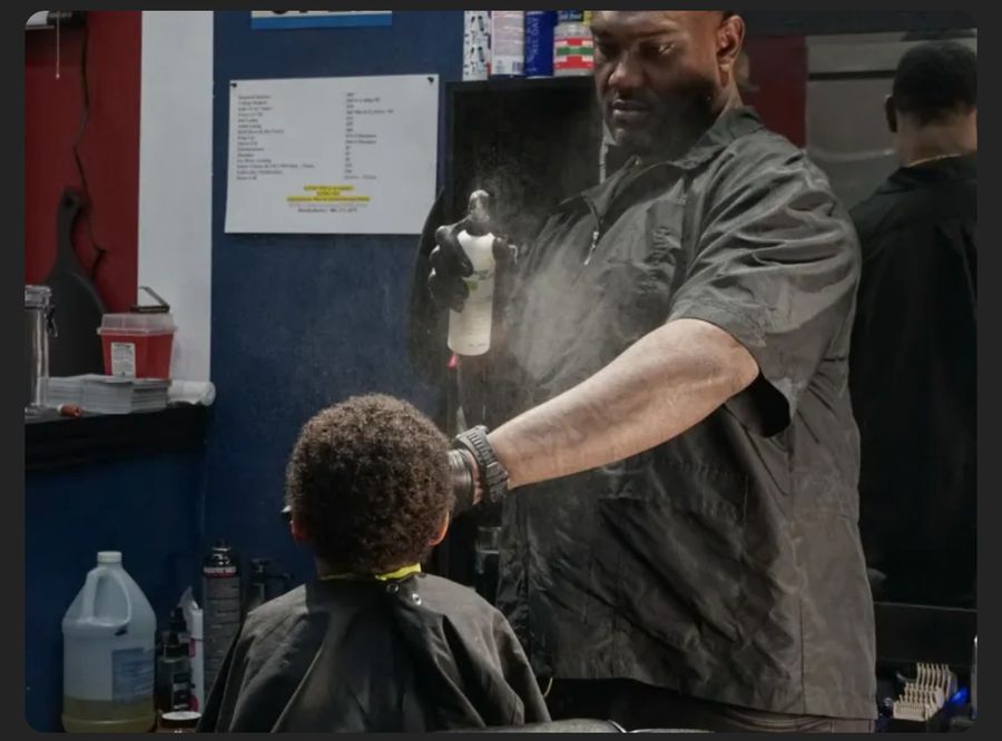 Gerald Blue, owner and barber at BlueDaBarber, cutting a client's hair