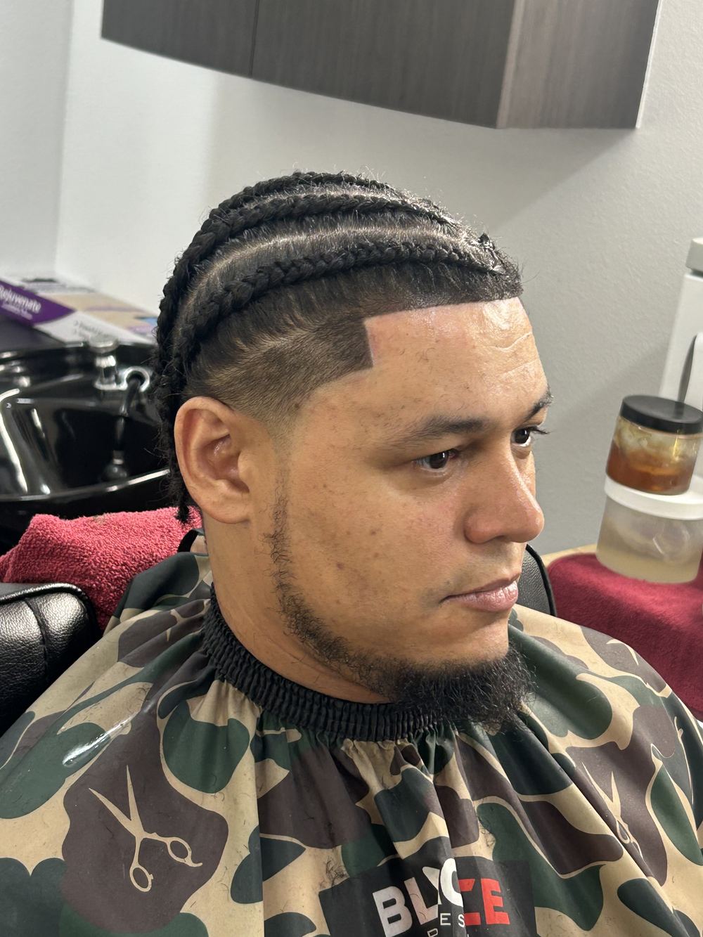 Men's cornrow braids with fade by BlueDaBarber